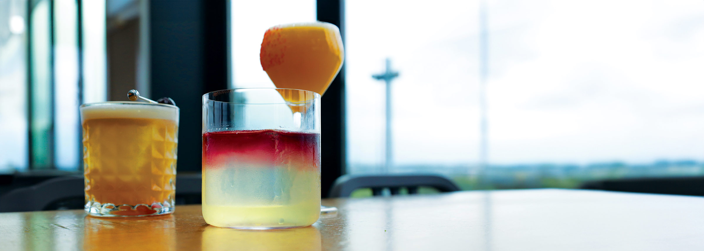 A close up of three of Lincoln Social's cocktails on a bartop.